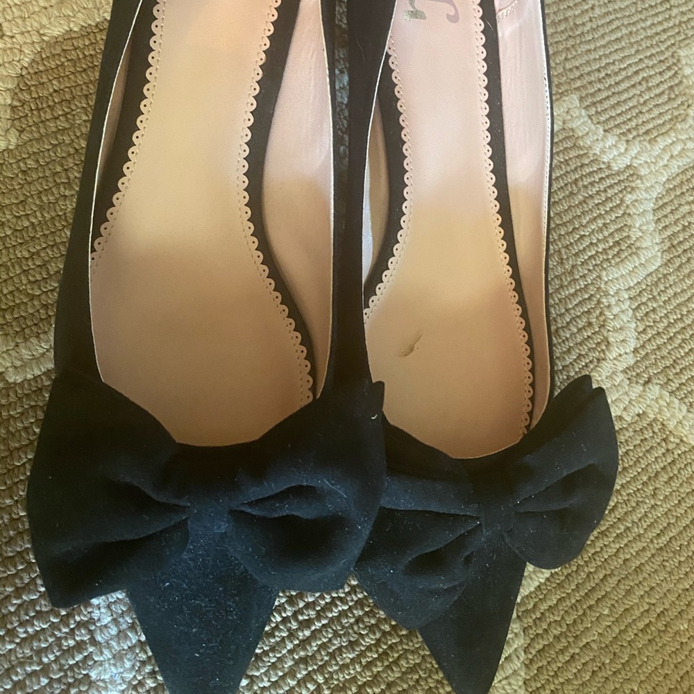 Faux suede kitten heel pumps with bow detail.